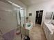 Bright bathroom featuring a shower, soaking tub, dual sinks, walk-in closet, and tile flooring for a luxurious experience at 8337 Ruby Heights Ave, Las Vegas, NV 89117