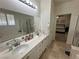 Large bathroom with double sinks, shower, tub, and tile flooring, leading to the main bedroom for added privacy and convenience at 8337 Ruby Heights Ave, Las Vegas, NV 89117