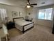 Bright main bedroom featuring a queen bed, carpet floors, and natural light from the windows, creating a cozy retreat at 8337 Ruby Heights Ave, Las Vegas, NV 89117