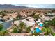 Stunning aerial view of a home with a pristine pool and lush landscaping in a beautiful neighborhood at 8633 Kennedy Heights Ct, Las Vegas, NV 89131