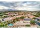 An expansive aerial perspective of a peaceful desert neighborhood, showcasing a blend of homes and desert landscapes at 8633 Kennedy Heights Ct, Las Vegas, NV 89131