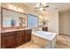 Well-lit bathroom features double sinks, soaking tub, and tiled accents at 8633 Kennedy Heights Ct, Las Vegas, NV 89131