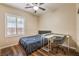 Cozy bedroom with a study desk, ceiling fan, and shuttered windows at 8633 Kennedy Heights Ct, Las Vegas, NV 89131