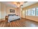 Spacious bedroom with hardwood floors, ceiling fan, and windows offering ample natural light at 8633 Kennedy Heights Ct, Las Vegas, NV 89131