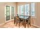 Cozy breakfast nook with a dark wood table, seating for four, and a pantry with etched glass at 8633 Kennedy Heights Ct, Las Vegas, NV 89131