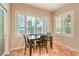 Bright breakfast nook with natural light, a dark wood table, and a pantry with etched glass at 8633 Kennedy Heights Ct, Las Vegas, NV 89131