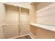 Walk-in closet features wooden laminate flooring, white trim, and multiple levels of shelving and storage at 8633 Kennedy Heights Ct, Las Vegas, NV 89131