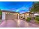 An inviting home with a private driveway, manicured landscaping, and an attached two-car garage under a dramatic sky at 8633 Kennedy Heights Ct, Las Vegas, NV 89131