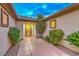 Inviting front entry with a decorative front door, stylish tiling, and manicured landscaping at 8633 Kennedy Heights Ct, Las Vegas, NV 89131