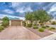 Charming single-story home featuring mature landscaping, a private driveway, and an attached two-car garage at 8633 Kennedy Heights Ct, Las Vegas, NV 89131
