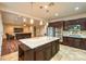 Open-concept kitchen with a center island, stainless steel appliances, and flows into the living room at 8633 Kennedy Heights Ct, Las Vegas, NV 89131