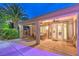 Covered patio featuring ceiling fans, an outdoor dining set, and beautiful glass doors at 8633 Kennedy Heights Ct, Las Vegas, NV 89131
