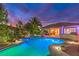 Inviting pool and outdoor kitchen area with lush landscaping, perfect for relaxing and entertaining at twilight at 8633 Kennedy Heights Ct, Las Vegas, NV 89131