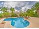 Sparkling pool surrounded by lush landscaping and a spacious patio perfect for outdoor entertaining at 8633 Kennedy Heights Ct, Las Vegas, NV 89131