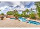 Freeform pool features a spa, lush landscaping, and a custom BBQ island for outdoor gatherings at 8633 Kennedy Heights Ct, Las Vegas, NV 89131
