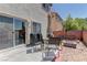 Backyard patio with seating, an umbrella, a grill, and a firepit at 9091 Jumping Jacks Ave, Las Vegas, NV 89178
