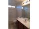 Bathroom featuring a combined tub and shower, vanity with sink, and mirror at 9091 Jumping Jacks Ave, Las Vegas, NV 89178