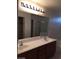 Bathroom vanity with double sinks and a large mirror at 9091 Jumping Jacks Ave, Las Vegas, NV 89178