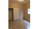 Bedroom featuring a closet with sliding doors and neutral tile flooring at 9091 Jumping Jacks Ave, Las Vegas, NV 89178