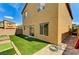 Well-maintained backyard with green turf and brick landscaping features, sunny skies at 934 Twincrest Ave, North Las Vegas, NV 89032
