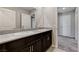 Well-lit bathroom featuring a double sink vanity with granite countertops at 934 Twincrest Ave, North Las Vegas, NV 89032