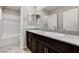 Modern bathroom featuring double sinks, granite countertops, and subway tile in the bath/shower at 934 Twincrest Ave, North Las Vegas, NV 89032