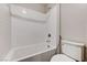 Clean white tiled bathtub with a shower and a toilet in the background at 934 Twincrest Ave, North Las Vegas, NV 89032