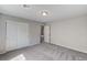 This bedroom features neutral walls, plush gray carpet, and a closet with sliding doors at 934 Twincrest Ave, North Las Vegas, NV 89032