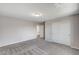 Spacious bedroom with neutral walls, plush gray carpet, and a closet with sliding doors at 934 Twincrest Ave, North Las Vegas, NV 89032