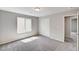 Spacious bedroom with neutral walls, plush gray carpet, and a closet with sliding doors at 934 Twincrest Ave, North Las Vegas, NV 89032
