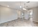Bright dining room with tile floors, contemporary lighting, and open access to other rooms at 934 Twincrest Ave, North Las Vegas, NV 89032