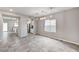 Open dining room with ceramic tile flooring, modern light fixtures, and large windows at 934 Twincrest Ave, North Las Vegas, NV 89032