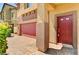 Close up of a brick driveway leading to a house with a red front door and garage at 934 Twincrest Ave, North Las Vegas, NV 89032
