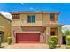 Charming two-story home with a red garage door, neat landscaping, and a brick driveway at 934 Twincrest Ave, North Las Vegas, NV 89032