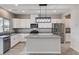 Bright kitchen with granite countertops, stainless steel appliances, modern lighting, and white cabinets at 934 Twincrest Ave, North Las Vegas, NV 89032