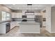 Modern kitchen features granite countertops, an island, stainless steel appliances, and white cabinets at 934 Twincrest Ave, North Las Vegas, NV 89032