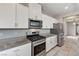 Well-equipped kitchen featuring stainless steel appliances and sleek white cabinetry at 934 Twincrest Ave, North Las Vegas, NV 89032