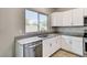 Kitchen with stainless steel dishwasher, sink, faucet and white cabinets with granite countertops at 934 Twincrest Ave, North Las Vegas, NV 89032