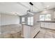 Open-concept kitchen and living area featuring a spacious island with granite countertops at 934 Twincrest Ave, North Las Vegas, NV 89032