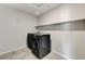 Well-equipped laundry room with modern washer and dryer, plus convenient shelving for storage. Fresh and functional at 934 Twincrest Ave, North Las Vegas, NV 89032