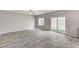 Open living room with tile floors, ceiling fan, and sliding glass door to the backyard at 934 Twincrest Ave, North Las Vegas, NV 89032