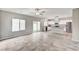 Open-concept living room and kitchen with stainless steel appliances, tile floors and natural light at 934 Twincrest Ave, North Las Vegas, NV 89032