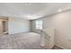 Spacious carpeted loft area with natural light and staircase access at 934 Twincrest Ave, North Las Vegas, NV 89032