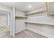 Spacious walk-in closet with built-in shelving and neutral carpeting, offering ample storage for clothing and accessories at 934 Twincrest Ave, North Las Vegas, NV 89032