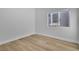 Bedroom featuring wood flooring, white walls, and a bright window at 10200 Wood Work Ln, Las Vegas, NV 89135