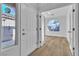 Welcoming entryway featuring sleek floors, white front door, and natural light at 10200 Wood Work Ln, Las Vegas, NV 89135