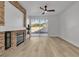 Bright living room features wood floors, a stone fireplace, and sliding glass doors to the backyard at 10200 Wood Work Ln, Las Vegas, NV 89135