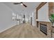 Spacious living room with a stone fireplace, wood-look floors, and recessed lighting throughout at 10200 Wood Work Ln, Las Vegas, NV 89135