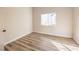 Bright bedroom features new wood-look flooring and a large window at 10205 Birch Bluff Ln, Las Vegas, NV 89145