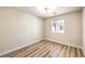 Bright bedroom features new wood-look flooring and a contemporary light fixture at 10205 Birch Bluff Ln, Las Vegas, NV 89145